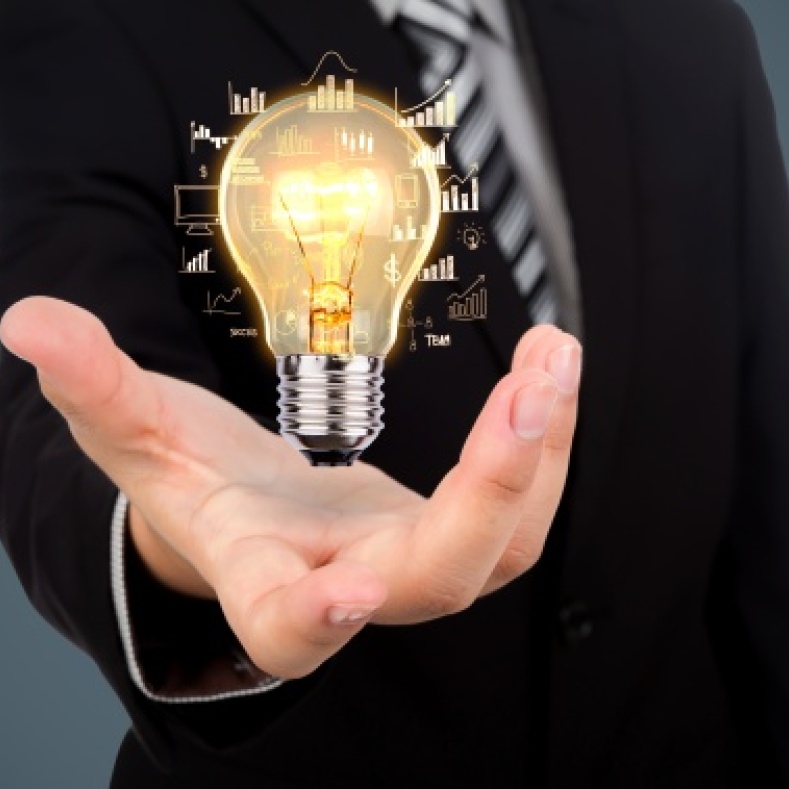 Light bulb lights up in a man's hand