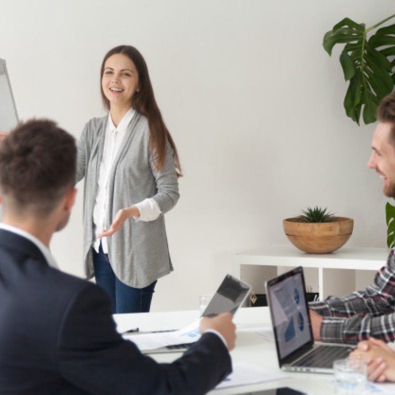 Woman presents an overview to her colleagues