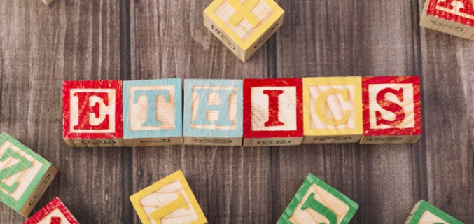 Wooden building blocks with wooden letters, put together to make Ethics