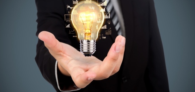 Light bulb lights up in a man's hand